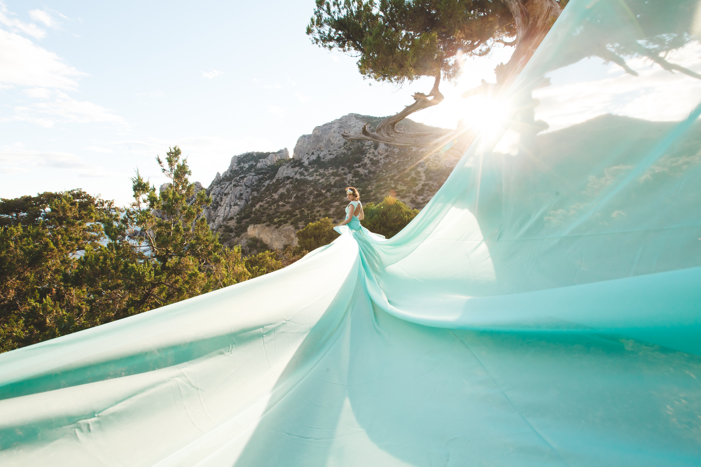 Bride in Nature in the Mountains near the Water. Dress Color Tiffany.